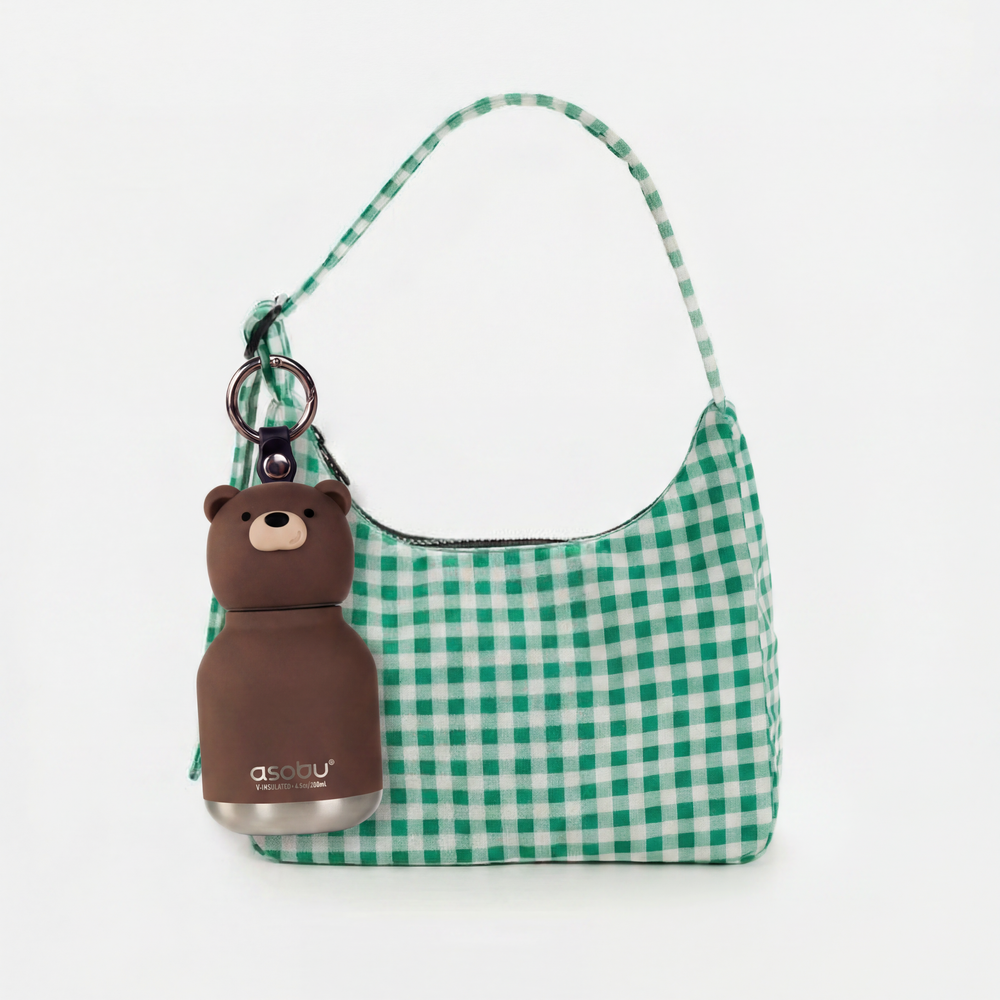Green checkered handbag with a bear-shaped bottle holder on a white background