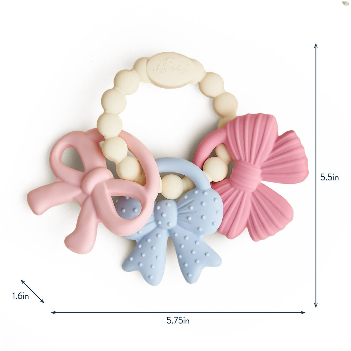 Baby teething ring with pink and blue designs on a white background