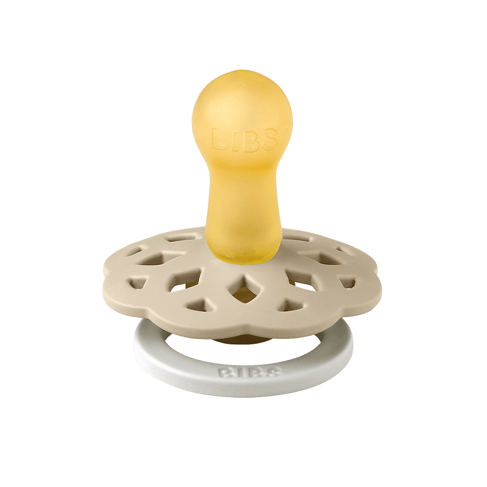 Yellow and beige pacifier on a blue background