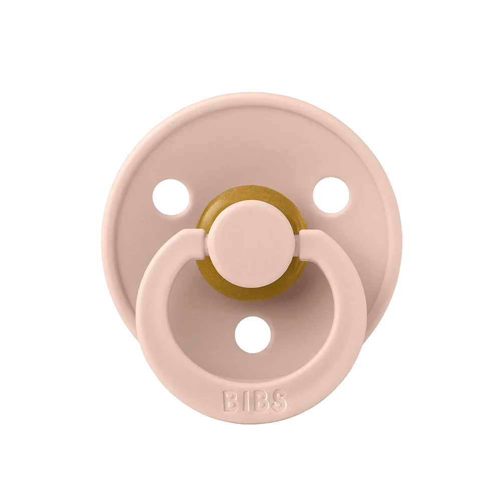 Pink pacifier with gold center on a white background