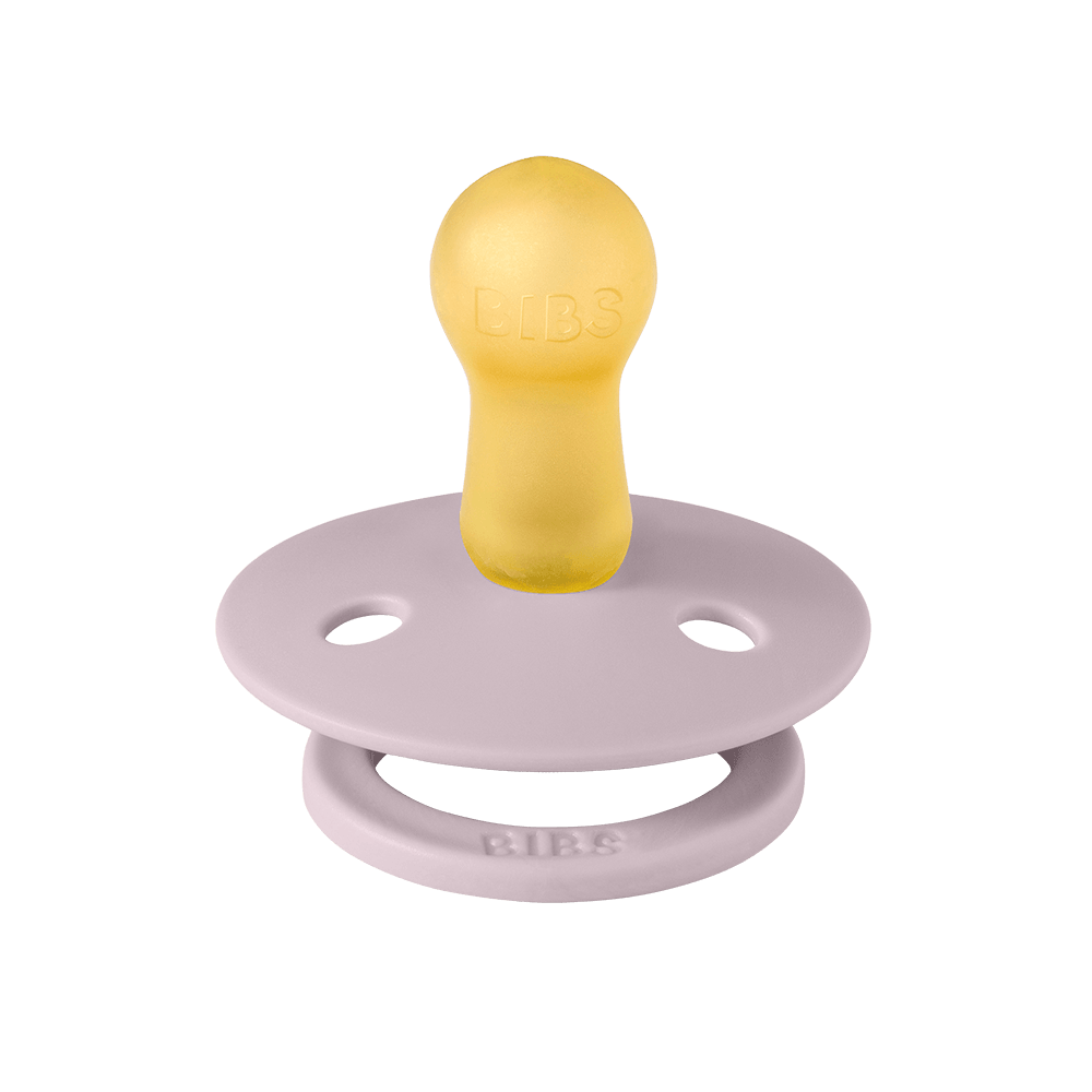 Yellow and pink pacifier on a dark green background