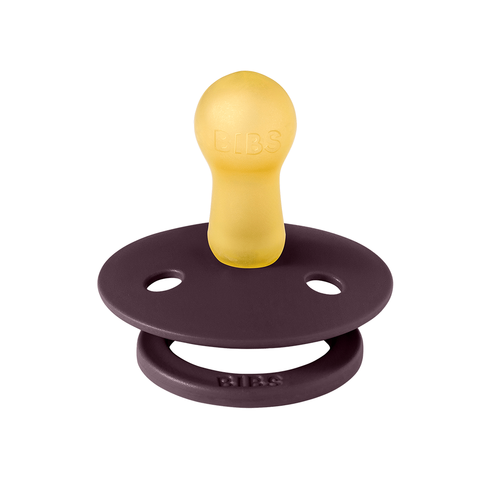 Purple and yellow pacifier on a white background