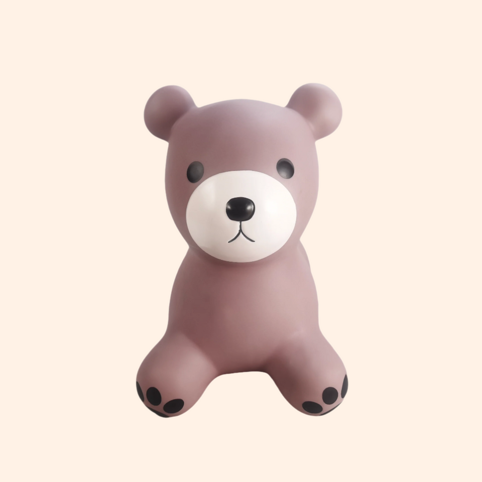 Brown teddy bear toy on a beige background