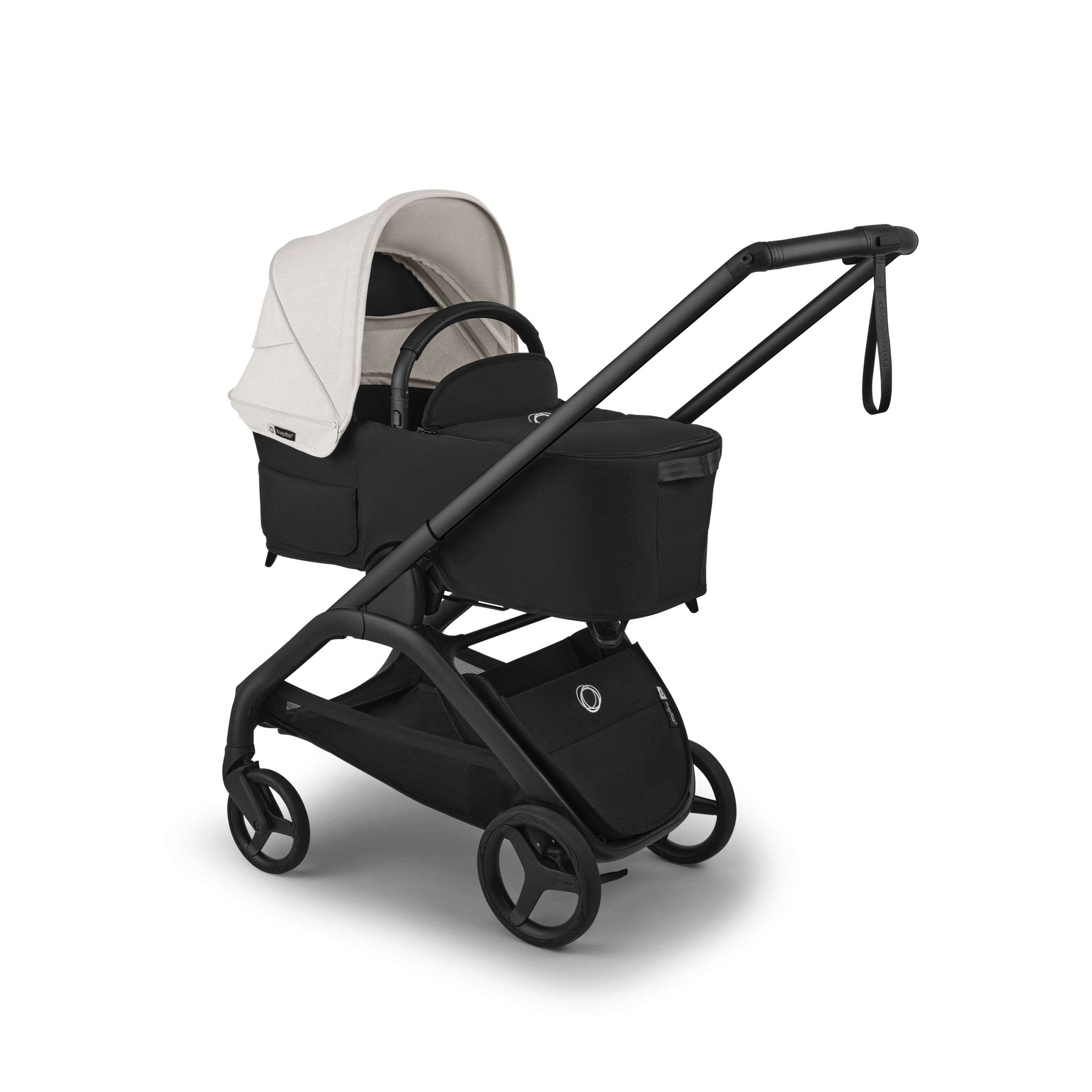 A stroller and bassinet travel system shown on a clean white background. The system features a black stroller base, black wheels, a black handlebar, and a light beige/cream hood and bassinet cover.