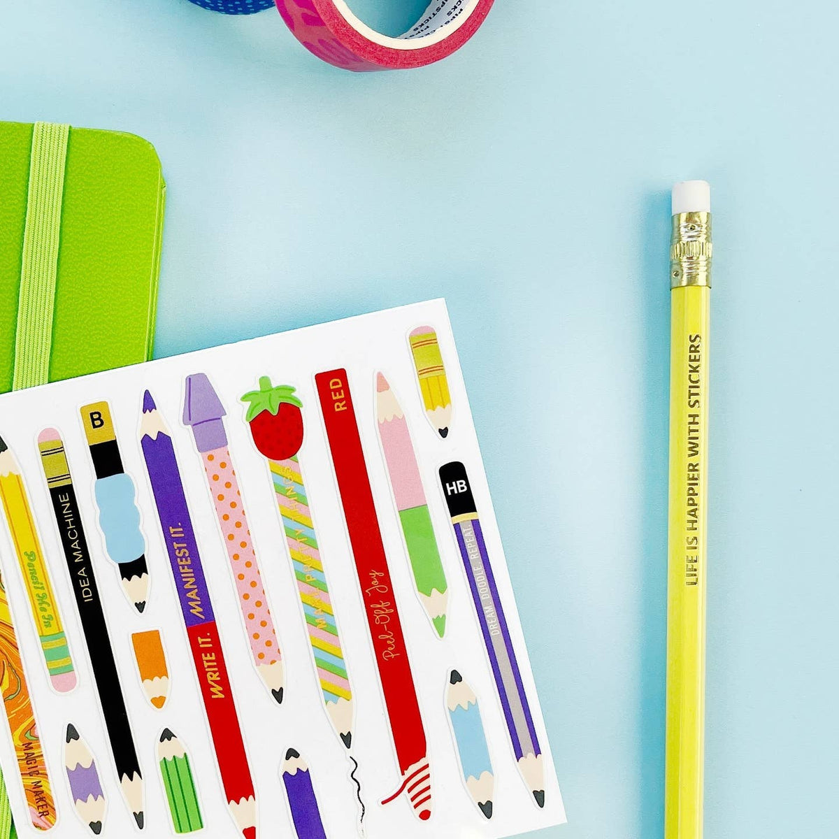 Colorful stationery items including pencils and a notebook on a light blue background
