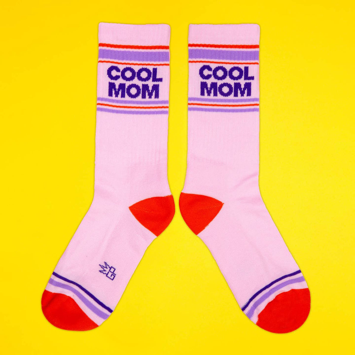 Pink socks with 'Cool Mom' text on a yellow background