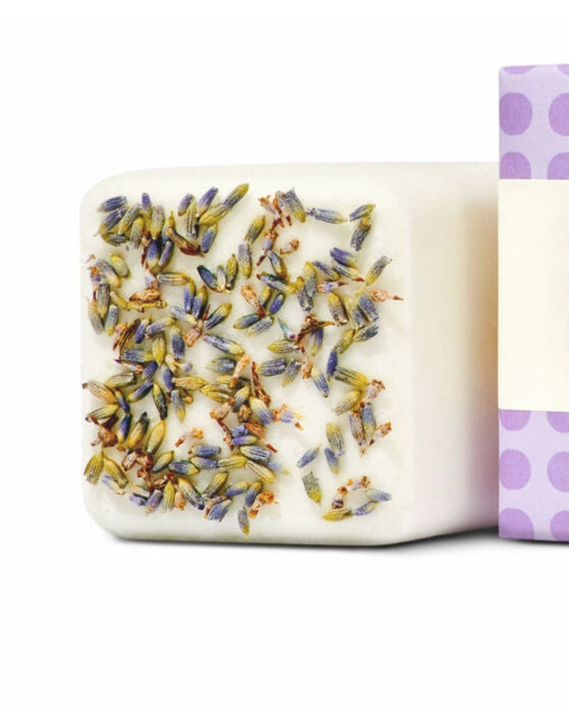 Bar of soap with lavender flowers on a white background