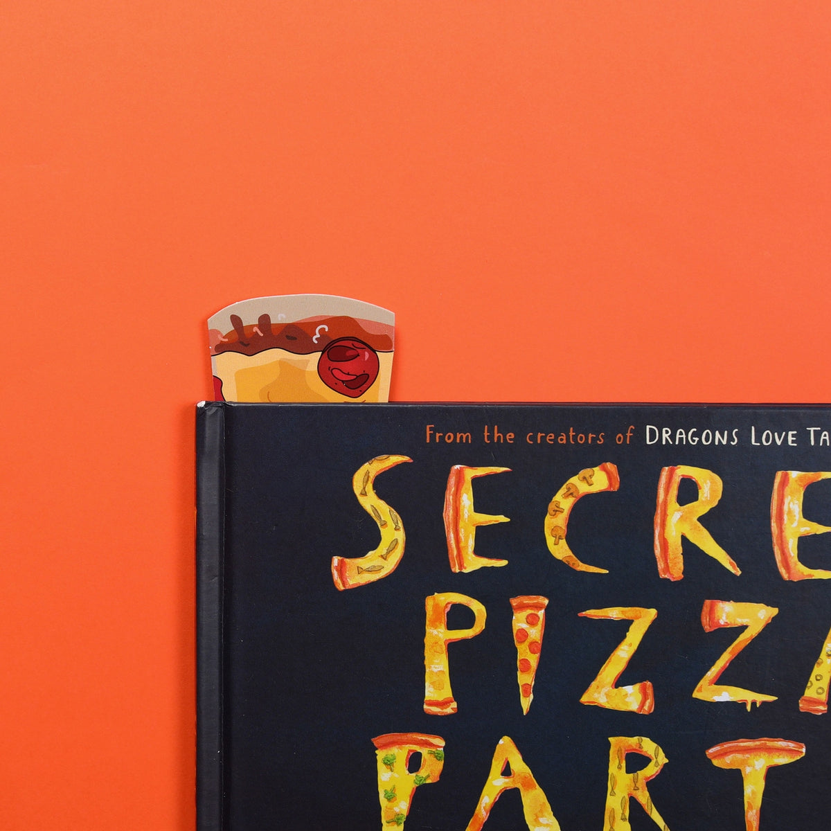 Book titled 'Secret Pizza Party' with a slice of pizza on an orange background