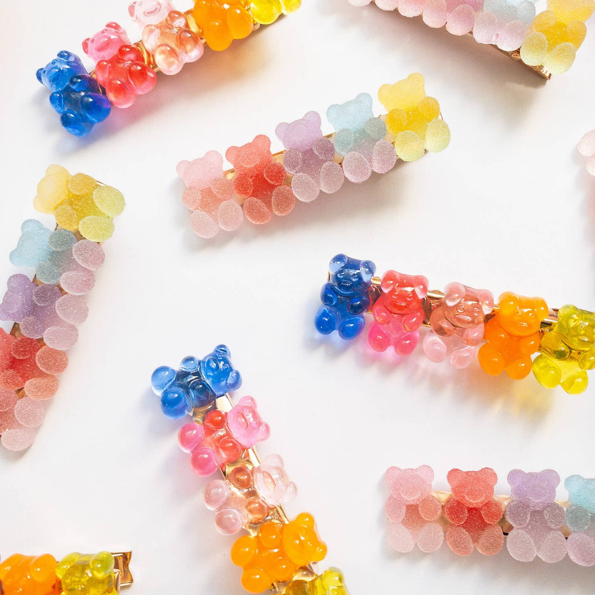 Colorful gummy bear-shaped hair clips on a white background