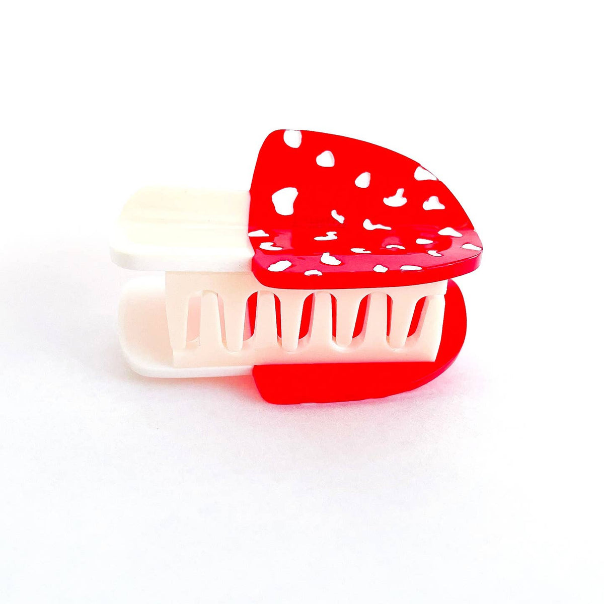 Red and white mushroom-shaped container on a white background