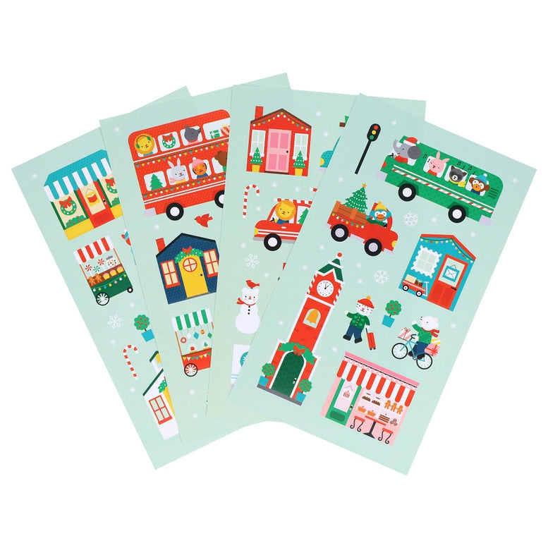 A product photo of the Christmas Town Mini Sticker Set by Petit Collage featuring four vertical green sticker sheets displayed side-by-side with festive illustrations of holiday buildings, vehicles, and characters.