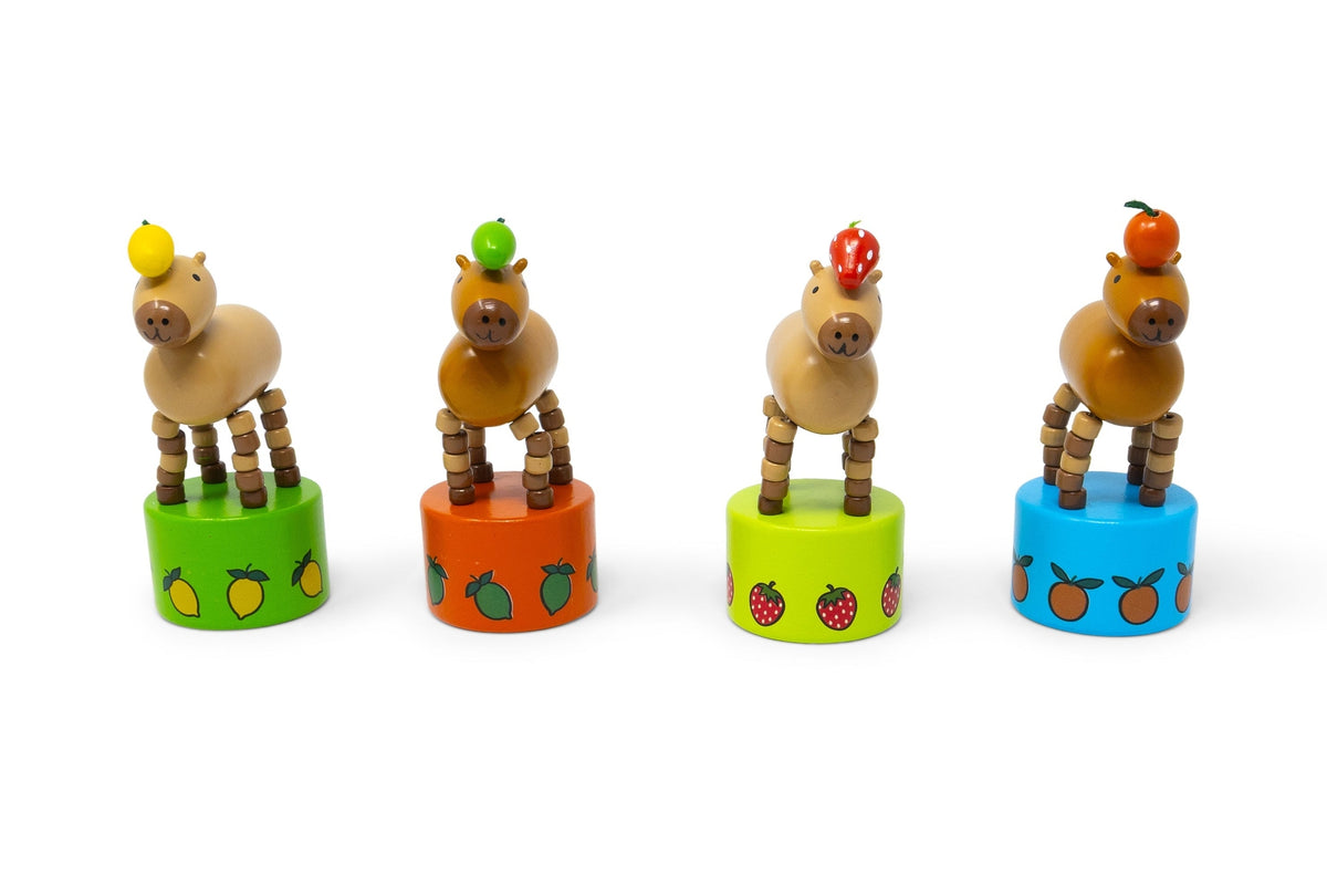 Four wooden animal figurines on colorful cylindrical stands with fruit patterns on a white background.