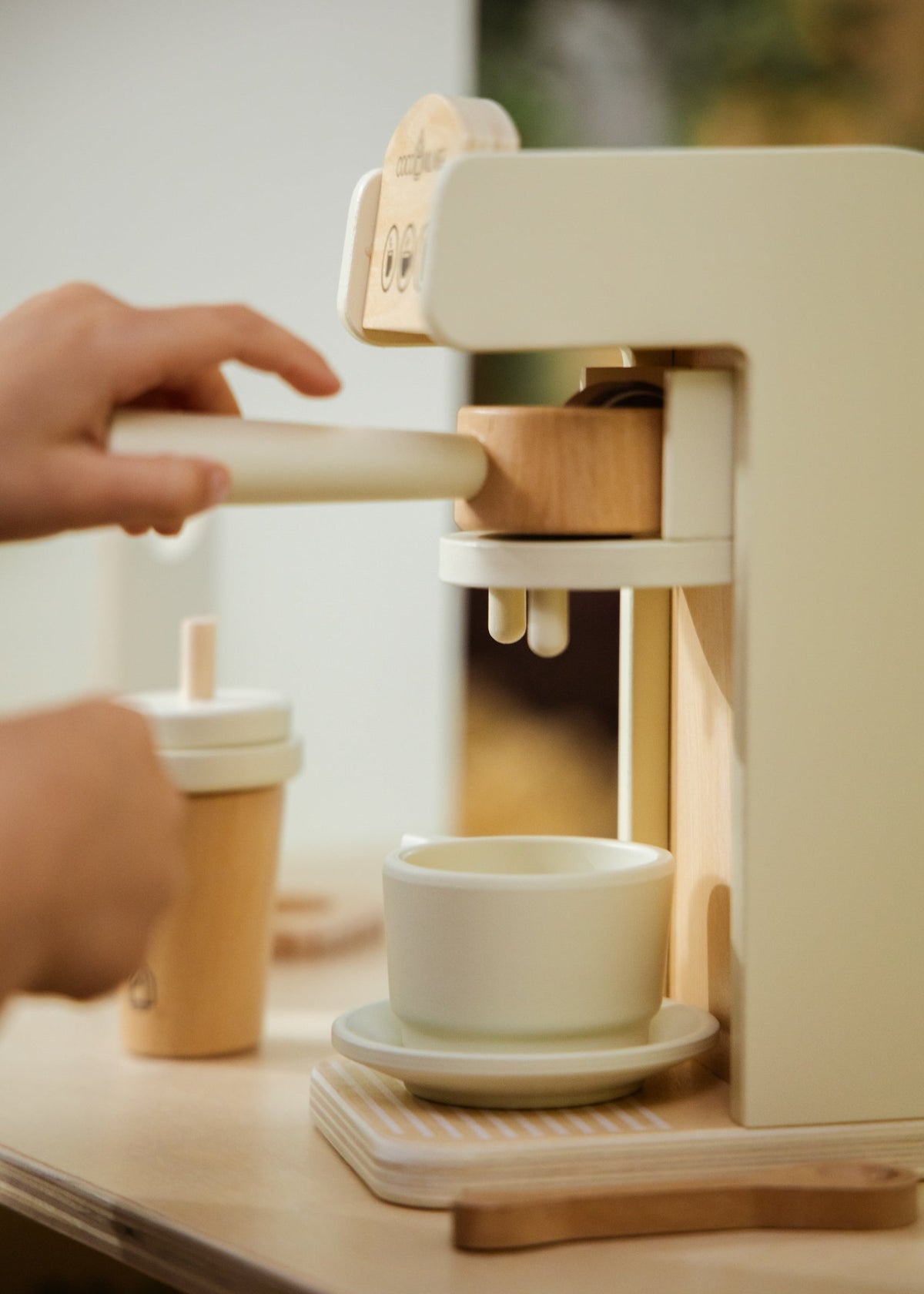 Person using a coffee machine to make a cup of coffee.