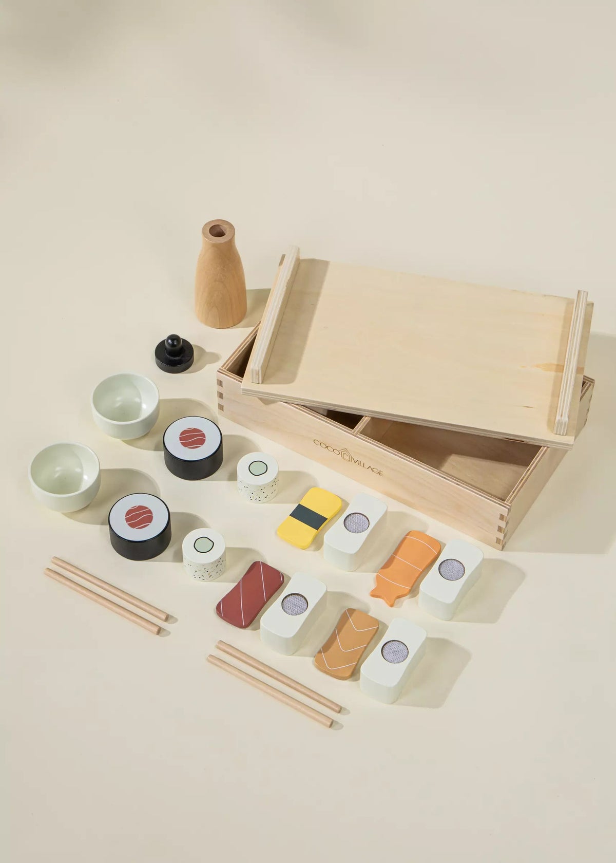 Wooden toy sushi set with a box on a beige background