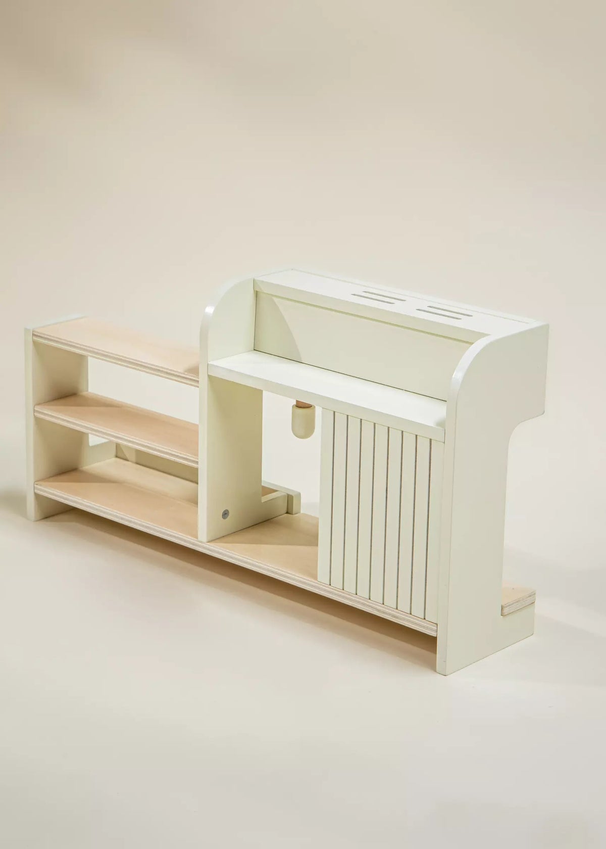 White and beige children's play kitchen set on a beige background