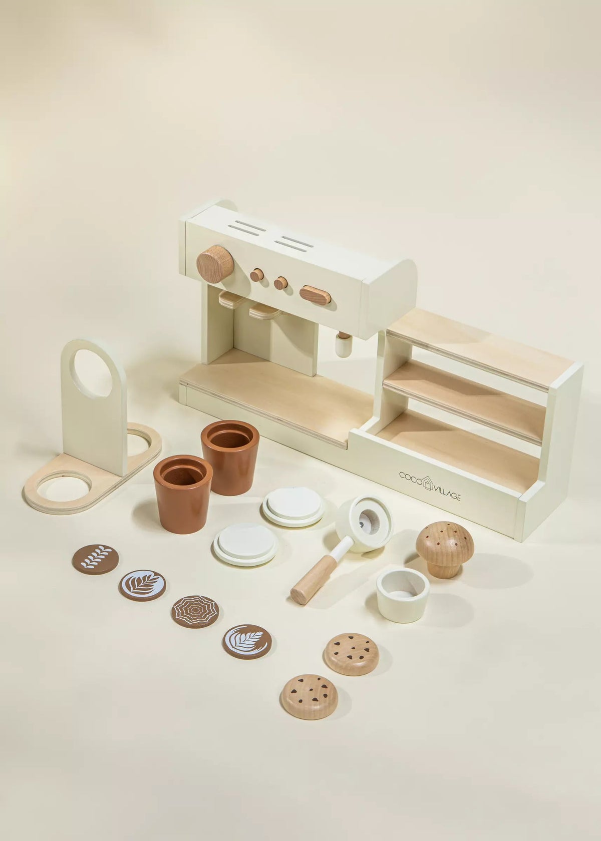 Wooden toy kitchen set with various accessories on a light background