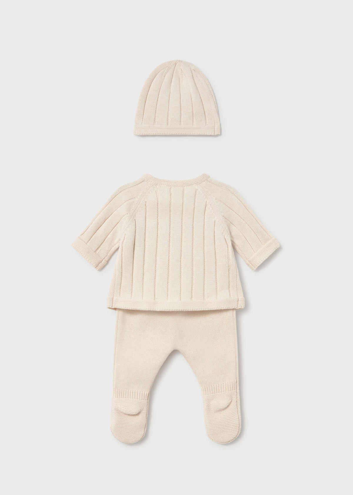 A three-piece baby knit outfit set in cream, featuring a short-sleeve footed sleeper, a matching beanie, and a ribbed long-sleeve top, laid out on a light gray background.
