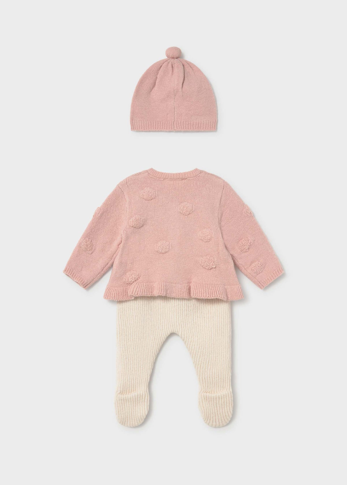 Pink baby sweater, hat, and pants set on a light gray background