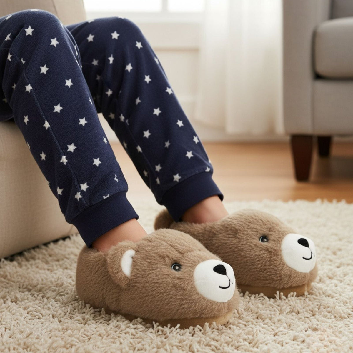 Person wearing navy pajama pants with white stars and brown bear slippers on a carpeted floor.