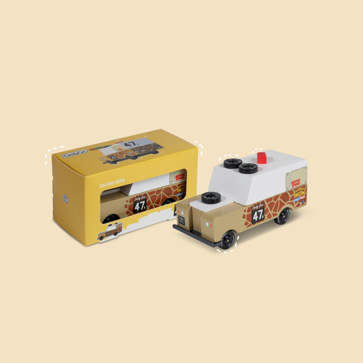 Toy truck with giraffe pattern and packaging on a beige background