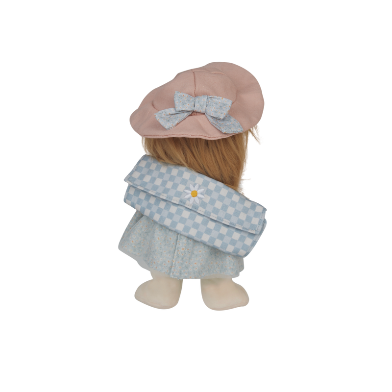 Stuffed doll with a pink hat and blue checkered coat on a white background