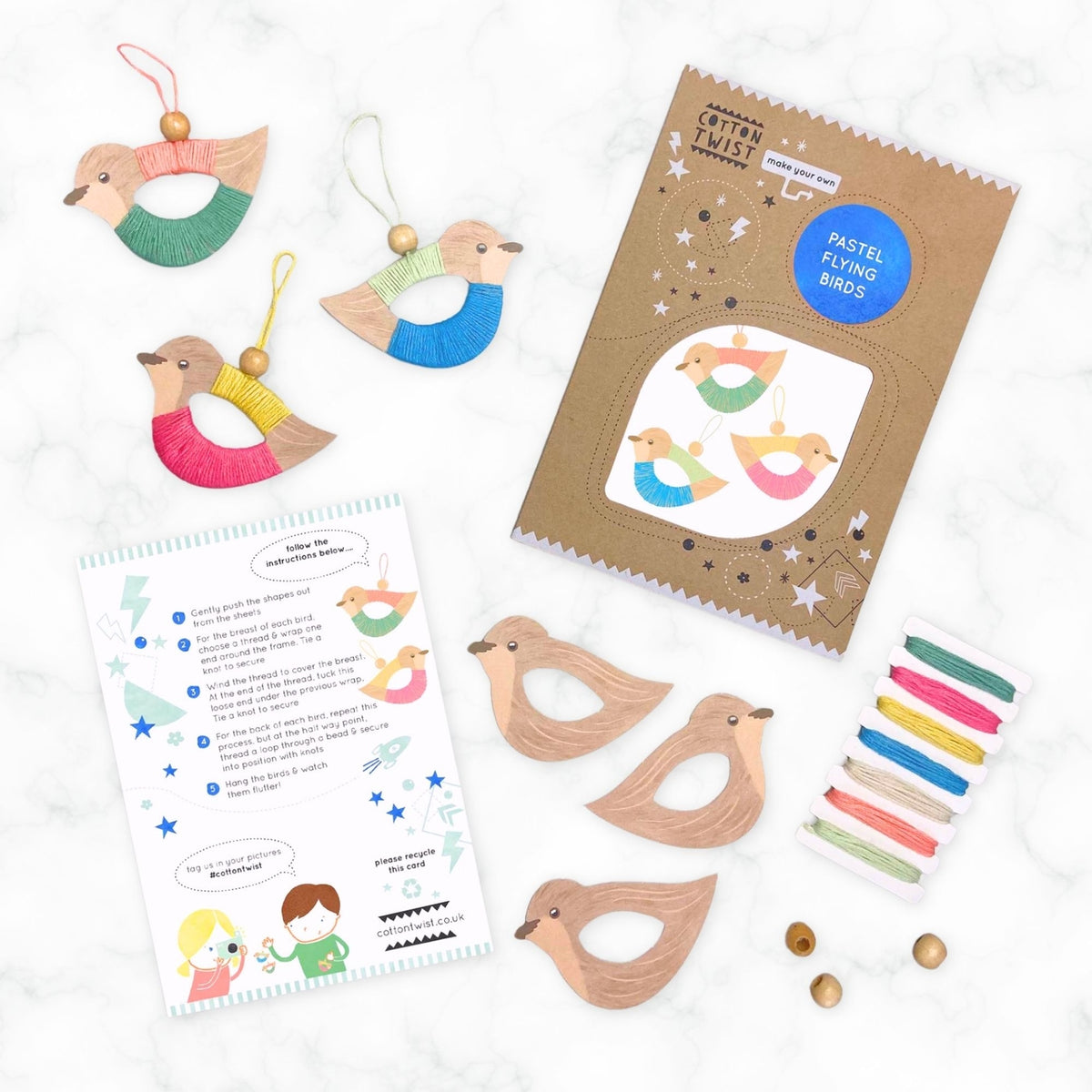 Bird-themed children's craft kit with wooden birds, colorful pastels, and instructions on a white background.
