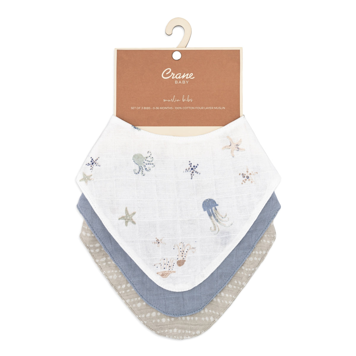 Set of baby bibs with sea-themed design on a Crane Baby branded card.