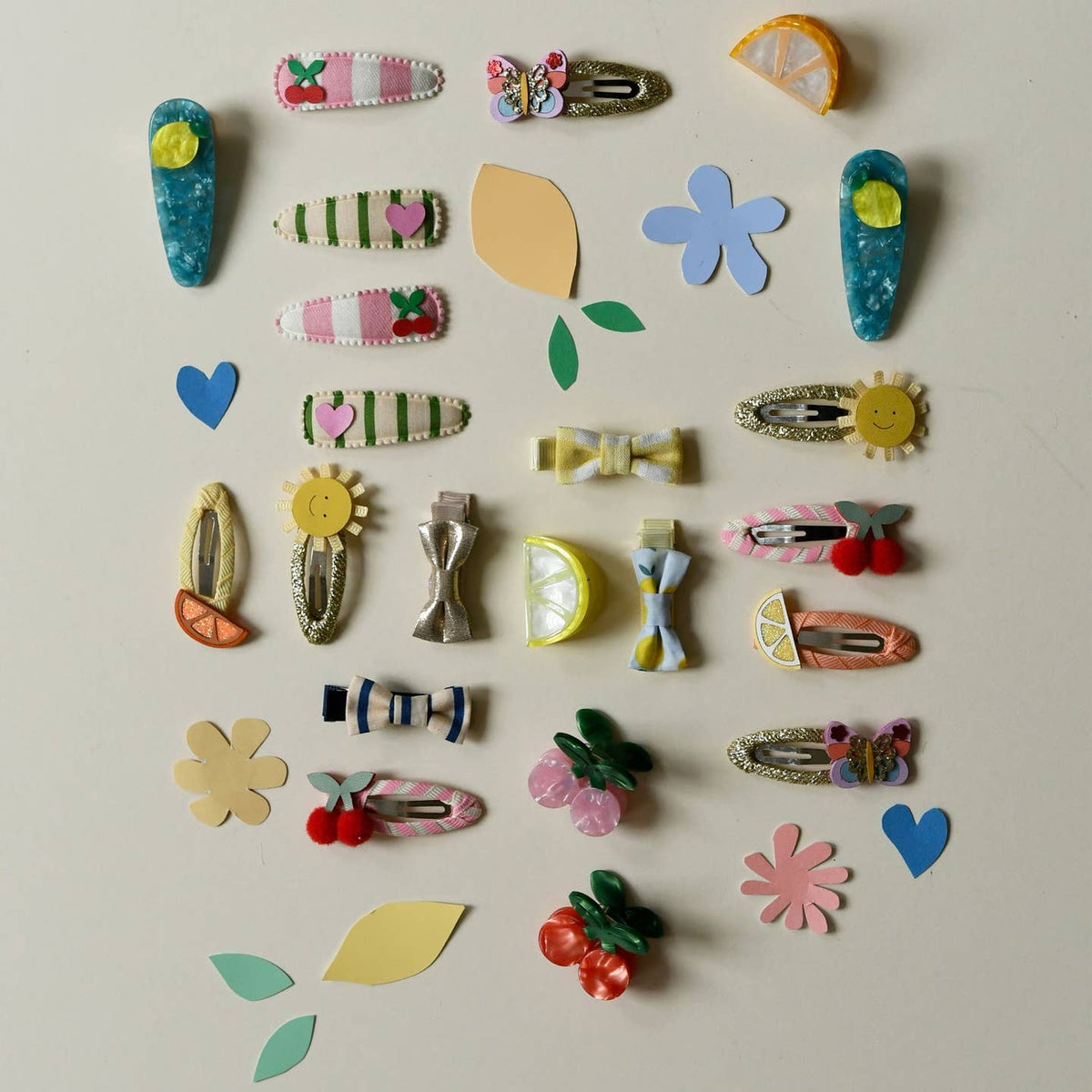 Collection of colorful hair clips and accessories on a light background
