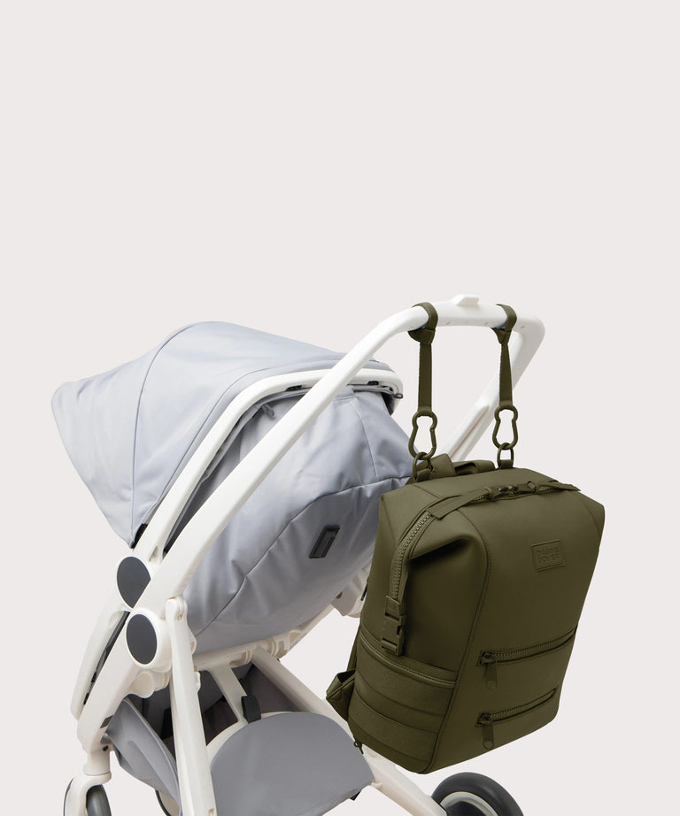 Navy blue backpack attached to a stroller on a light gray background