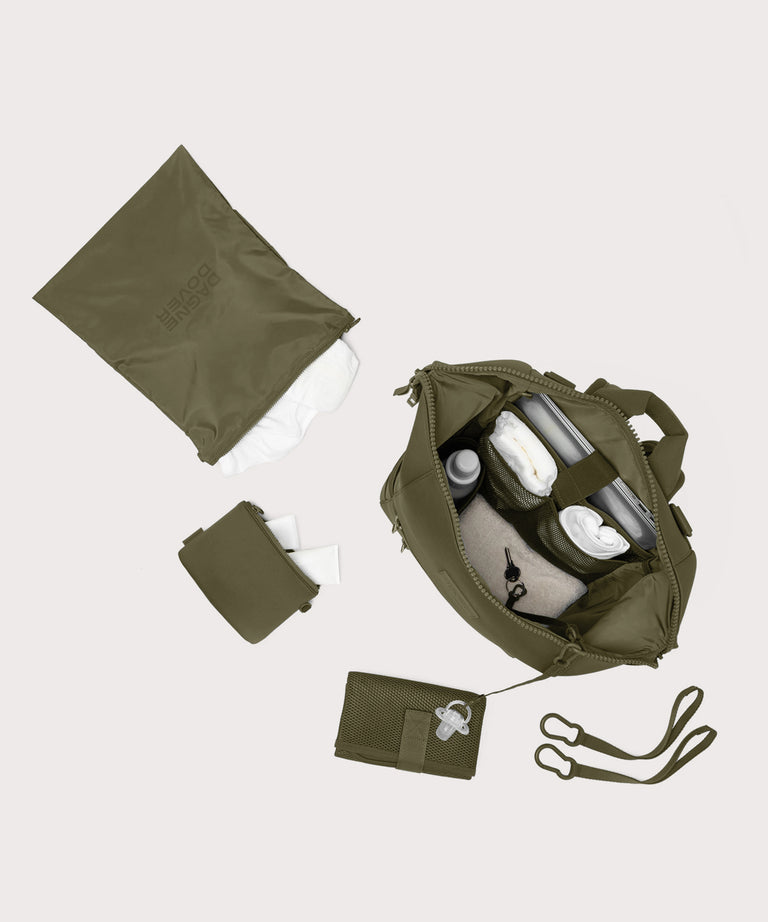 Navy blue travel bag with accessories on a light gray background