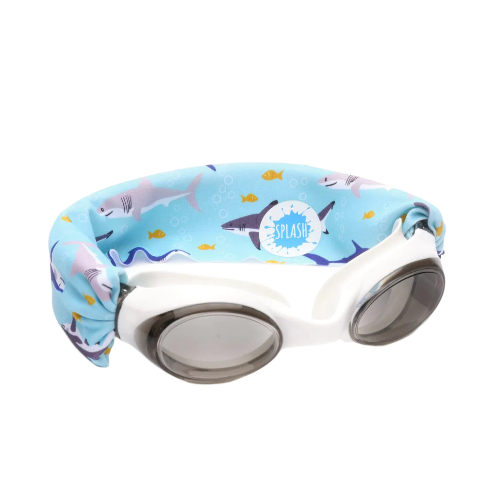 White swim goggles with a light blue elastic strap featuring a shark and fish pattern, shown on a plain white background.