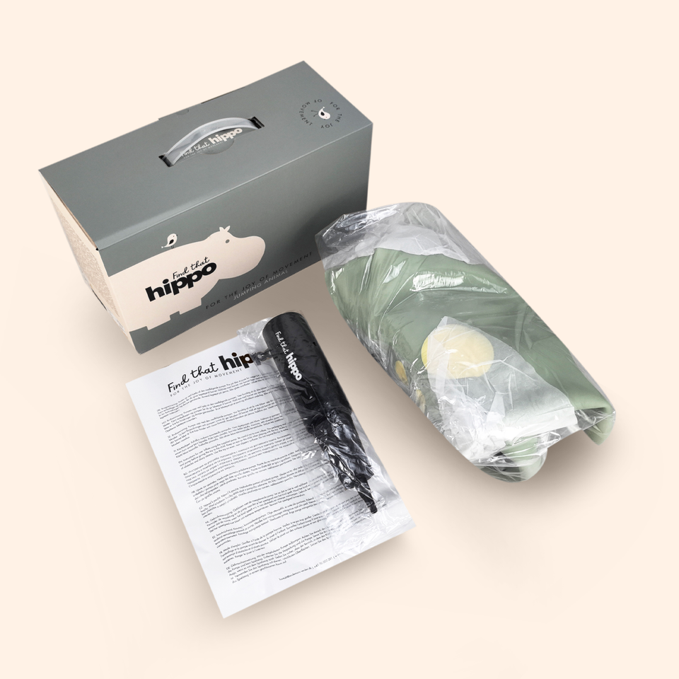 Product packaging with a box, paper, and wrapped item on a light background