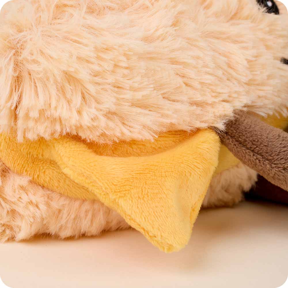 Close-up of a plush toy with yellow and brown colors on a light background