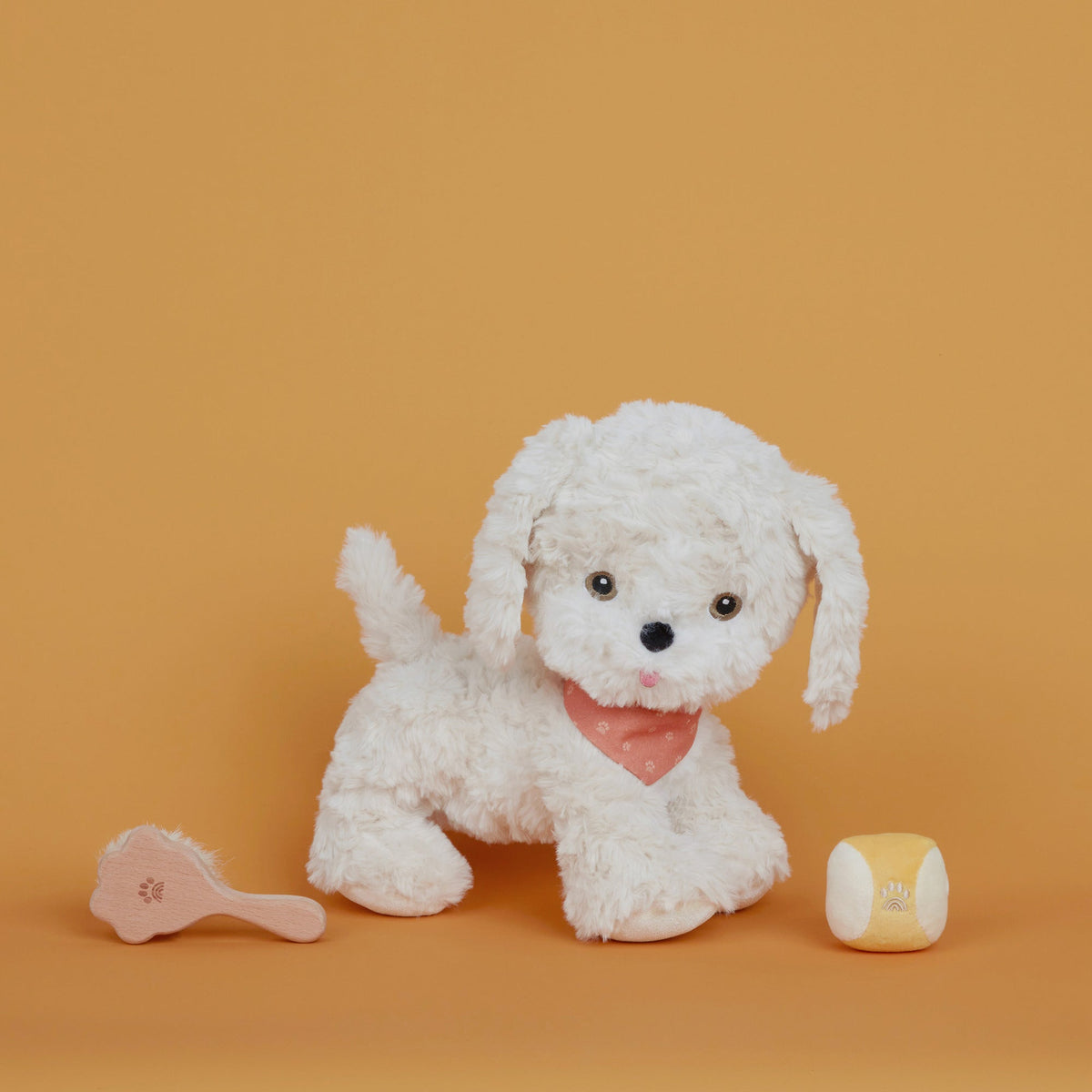 White plush dog toy with a pink bow tie on an orange background