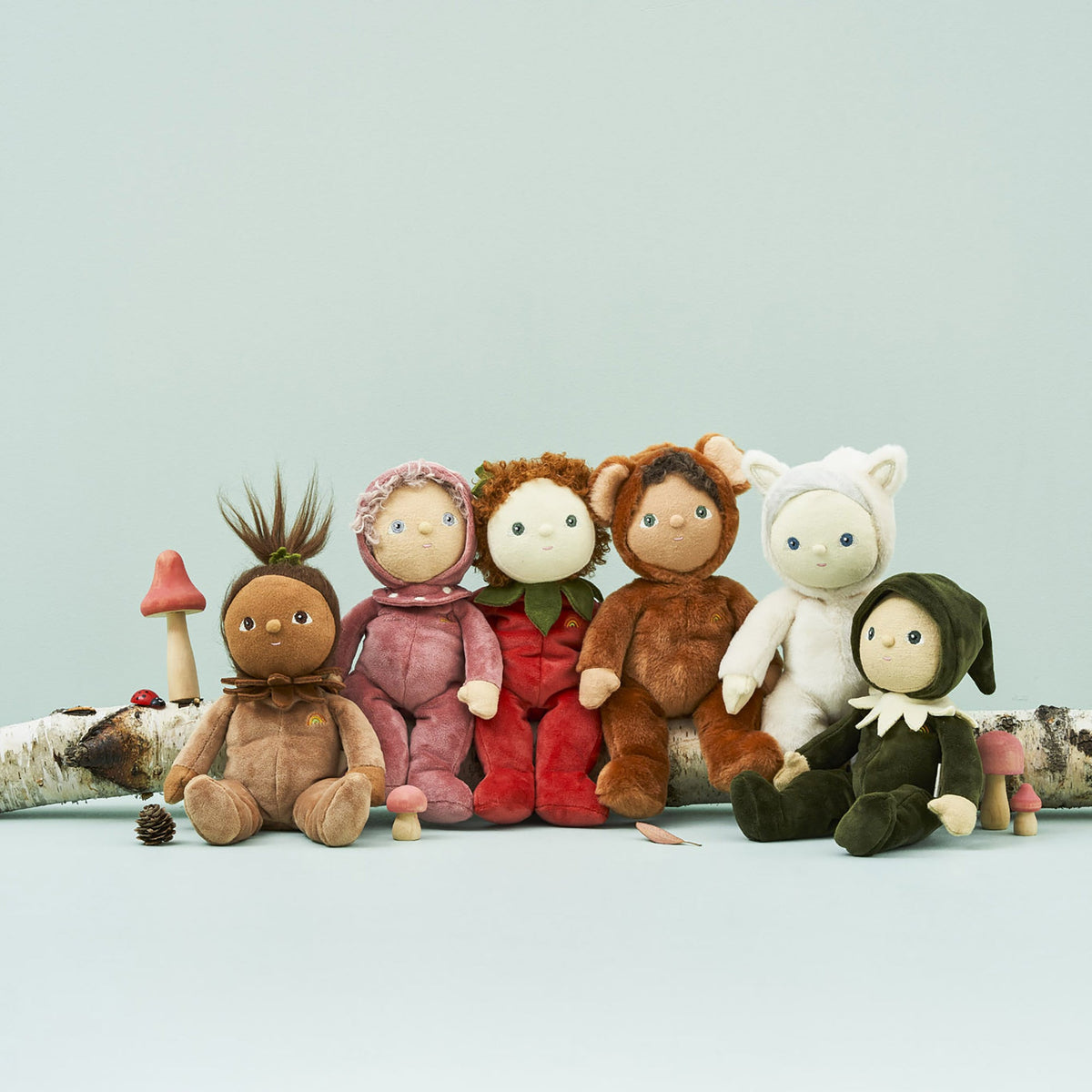 Set of plush toys resembling children in various costumes on a light blue background
