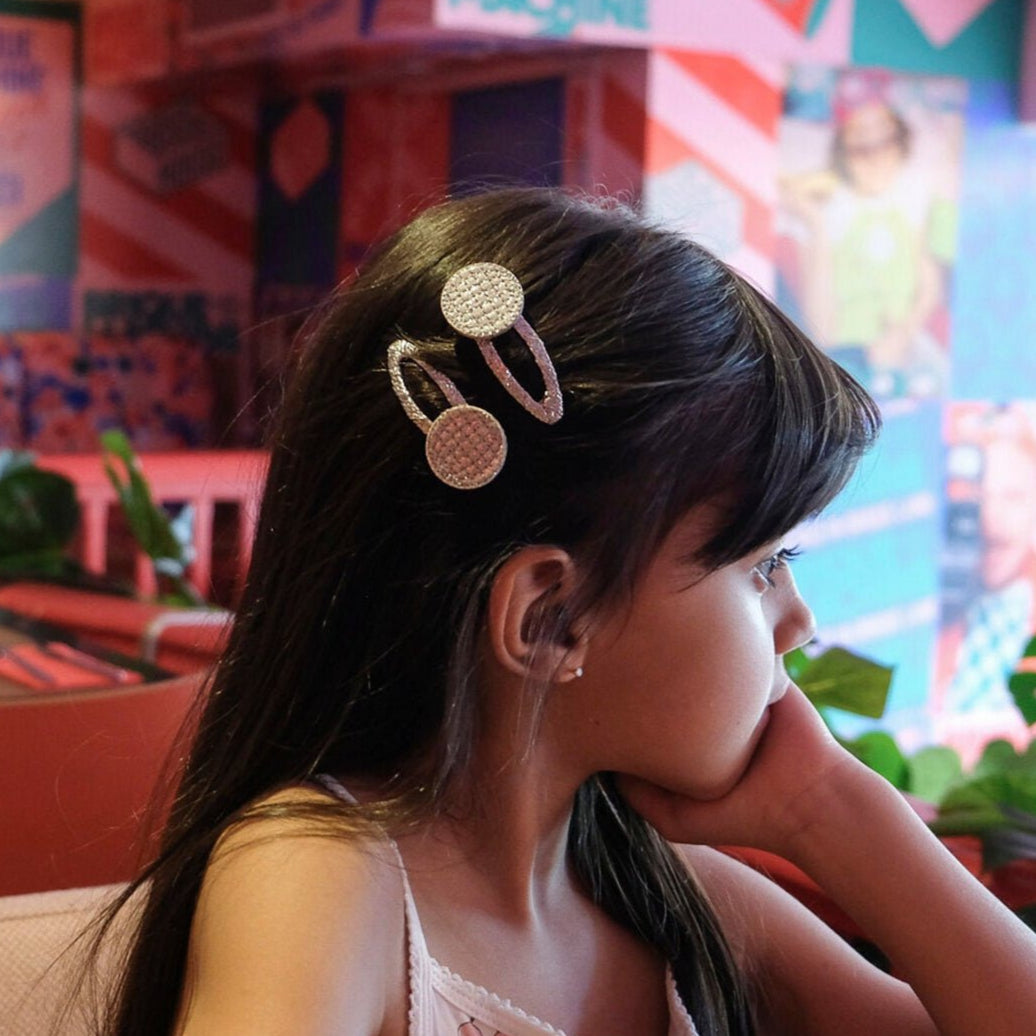 Young girl with decorative hair clips in a colorful indoor setting