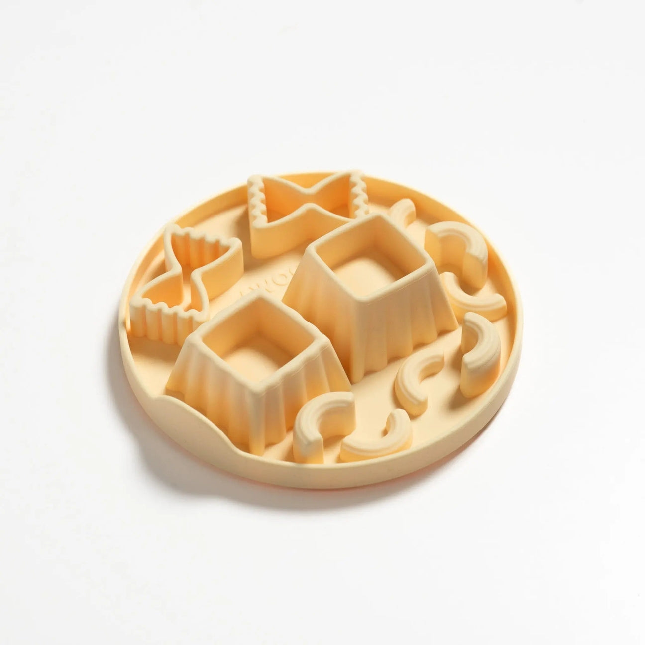 Round cookie cutter with various geometric shapes on a white background