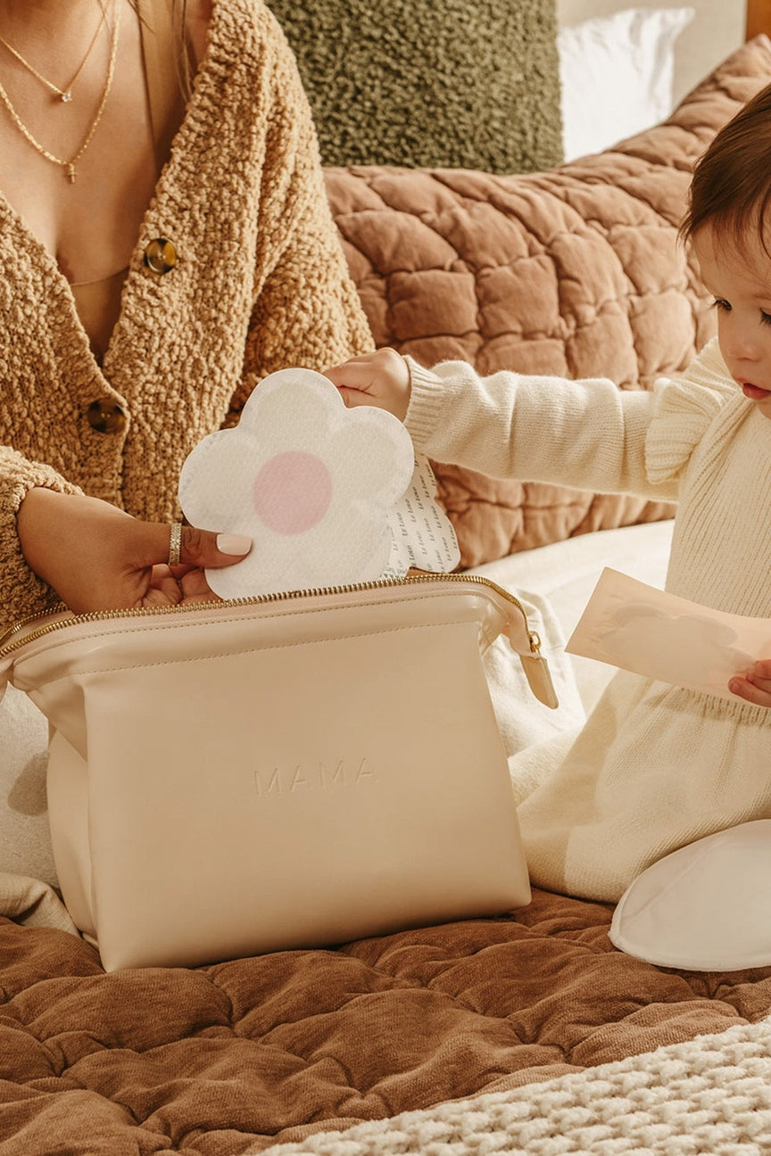 Woman and child interacting with a cloud-shaped pouch on a textured surface