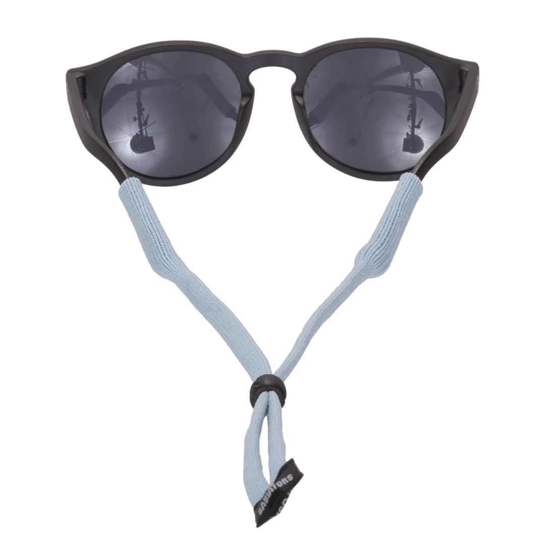Black kids sunglasses with a light blue cord on a white background