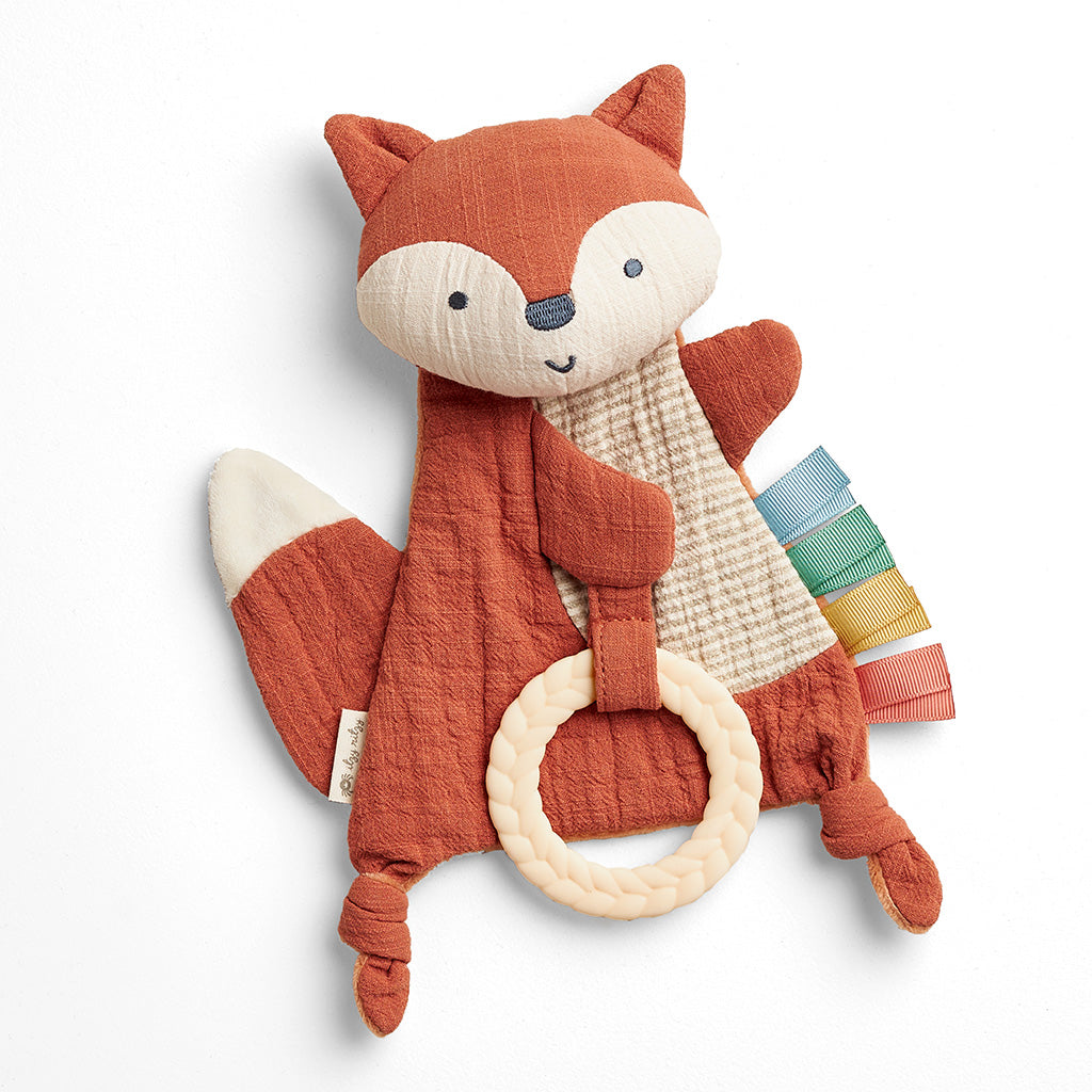 Plush fox toy with a ring and colorful scarf on a white background