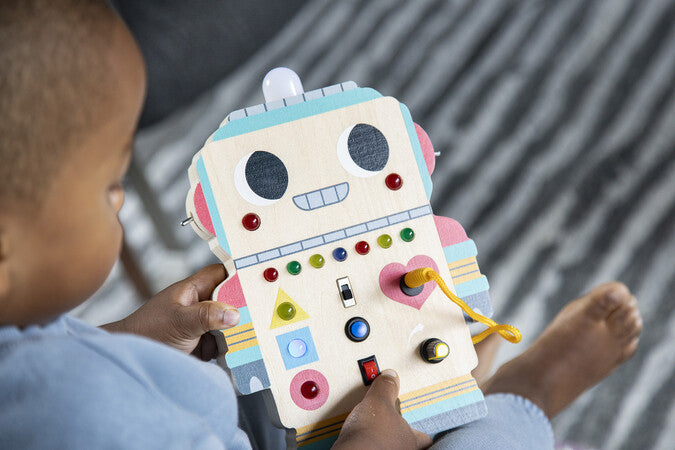 Child playing with a colorful robot-shaped educational toy.