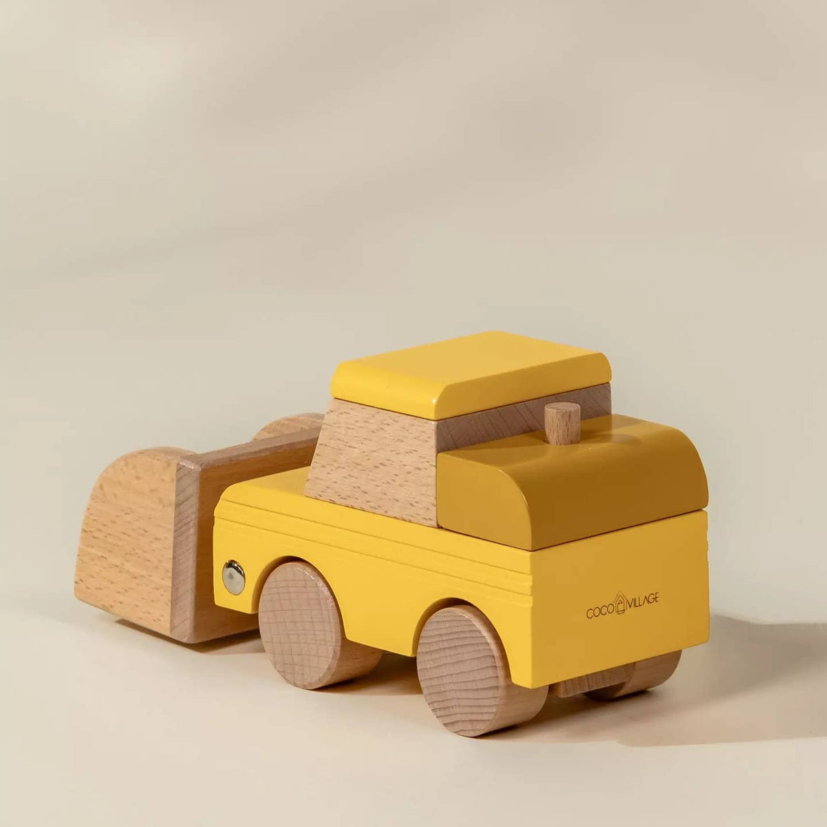 Wooden toy truck with yellow body and brown accents on a beige background