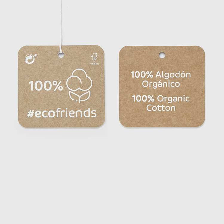 Two brown labels indicating 100% organic cotton on a white background