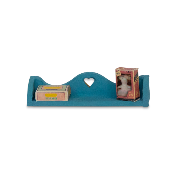 Blue decorative shelf with heart cutout holding two small boxes on a white background