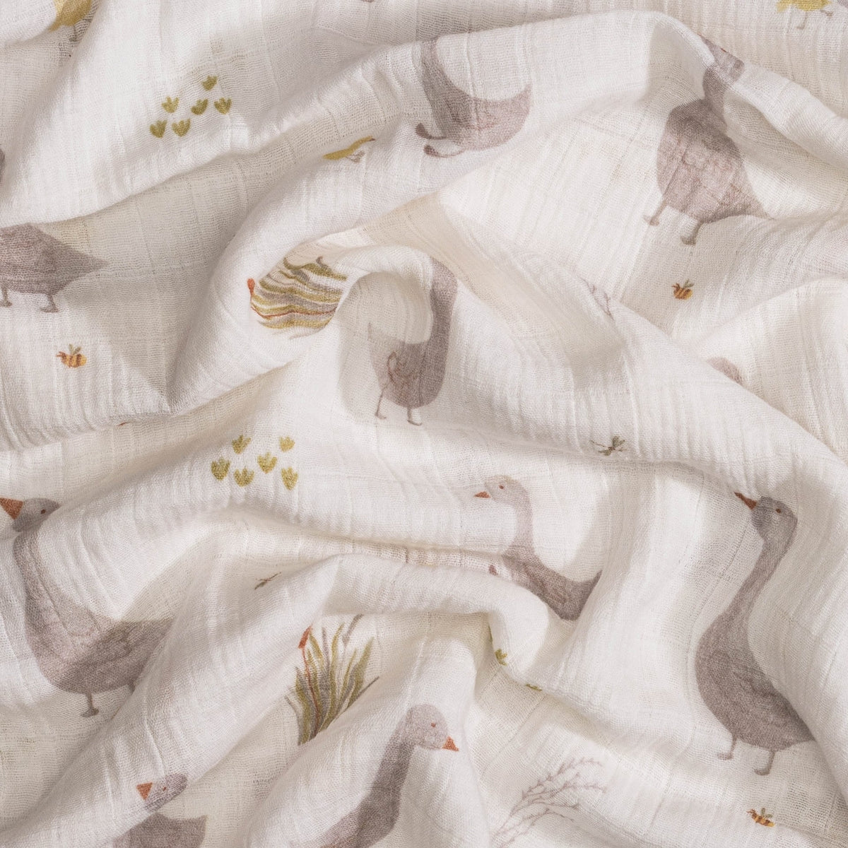 Fabric with a pattern of geese and plants on a white background