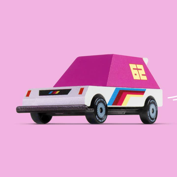 Toy car with a pink roof and colorful stripes on a pink background