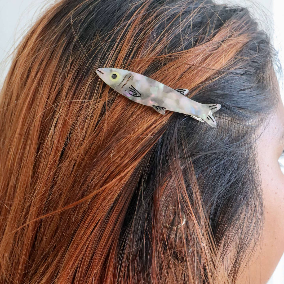 Fish-shaped hair clip in a person's hair