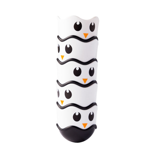 White and black toy with owl design on a white background