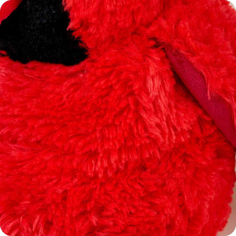A close-up view of the Red Cardinal by Warmies plush toy, highlighting its bright red fuzzy fur and black face details.