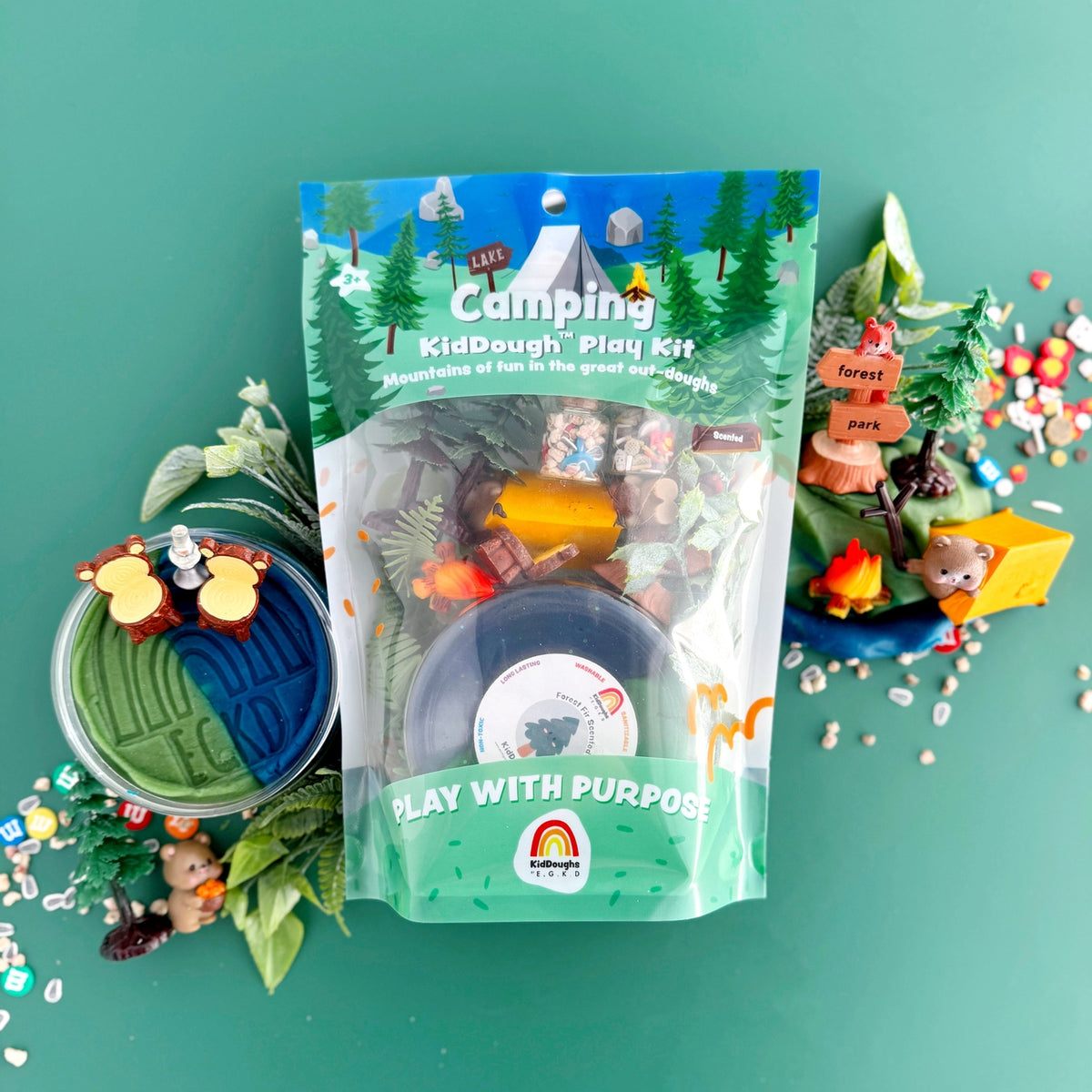 Camping kiddough play kit with toys on a green background